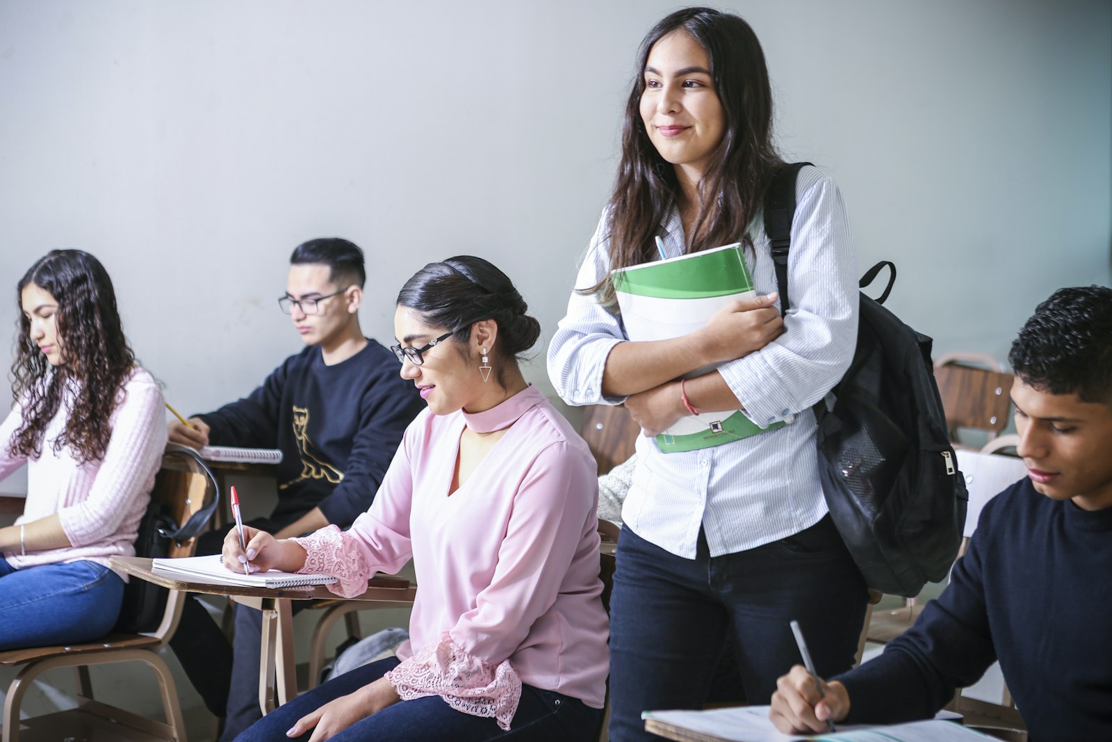 Students working at desks in a bright classroom
