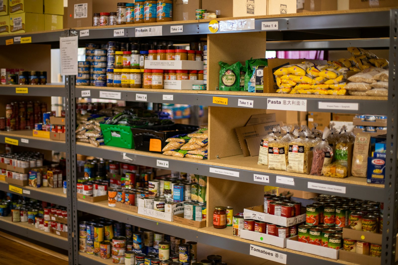 Stocked shelves of canned and dried food at a community food pantry